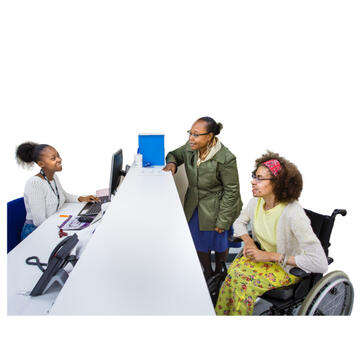 A woman sitting behind a desk and 2 people on the other side of it.