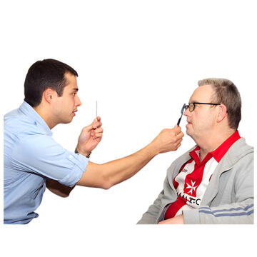 An optician looking at a man's eye.