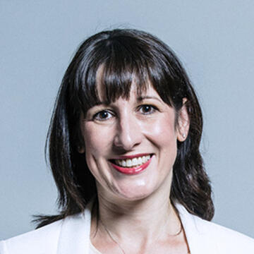 A woman smiling with shoulder length dark hair