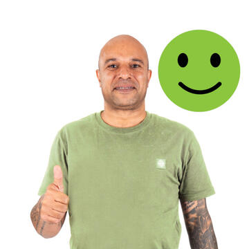 A man wearing a tshirt smiling with his thumb up.  Beside him is a smiley face emoji.