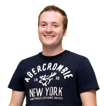 A man in a tshirt smiling.
