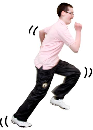 A boy running with movement marks by his arm and feet.