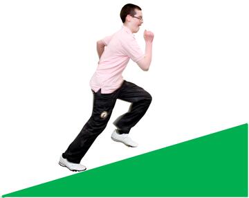 A boy running up a hill.