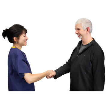 A man and a woman shaking hands and smiling.