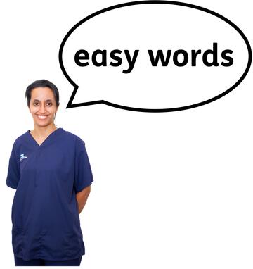 A woman wearing an NHS top with a speech bubble with easy words inside it.