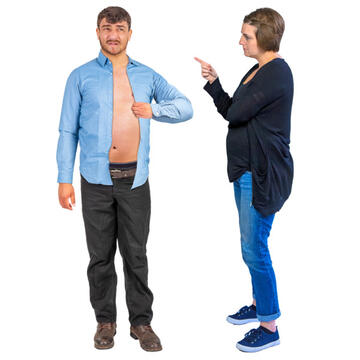 A woman pointing at a man who is undoing his shirt.