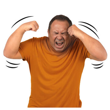 A man in pain hitting his face with his fists.