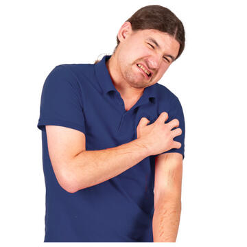 A man looking as if he is in pain and scratching his arm which has red marks on it.