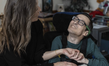 Man in wheel chair with support worker