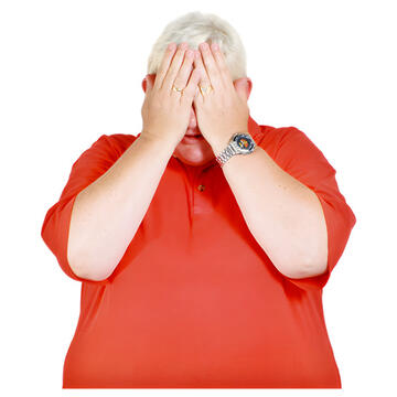 A woman with her hands in front of her face.