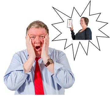 A man looking shocked with his hands on his cheeks.  Beside him is a spiky shape with a picture inside it of a woman laughing and holding up an image of a naked man on her phone.