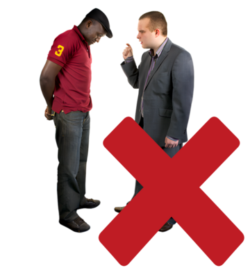 A red cross beside 2 men. One man is talking and has his finger up as if telling the other man off.  The other man has his head lowered.