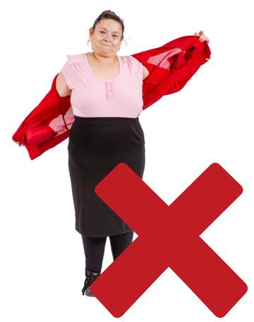 A cross beside a woman taking off her cardigan.