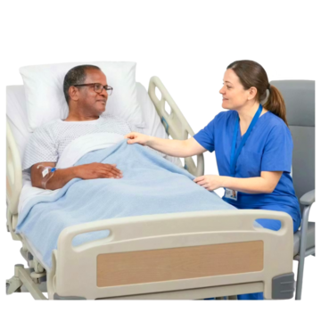 A man lying in a hospital bed.  Beside him is a nurse talking to him.
