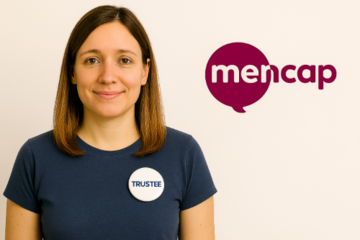 A woman wearing a Trustee badge on her Tshirt