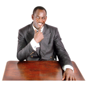 A man in a suit sitting at a desk thinking