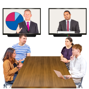 Four people sitting at a meeting table with two television screens showing 2 other meeting participants 