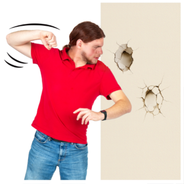 A man punching a wall and damaging it