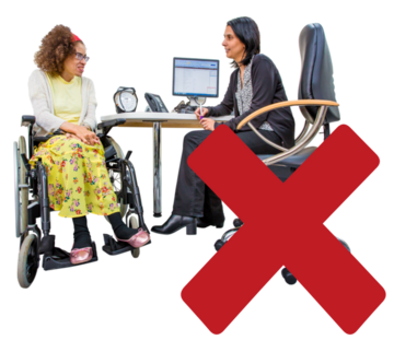 A cross beside a GP doctor who is sitting at her desk talking to a woman in a wheelchair.