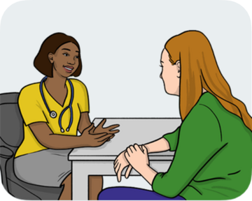 A woman sitting talking to a doctor who has a stethoscope around her neck.