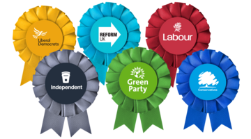 Rosettes from different political parties: Liberal Democrats, Reform UK, Labour, Independent, Green Party, Conservatives. 