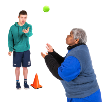 A boy throwing a ball to a woman who has her hands out ready to catch it.