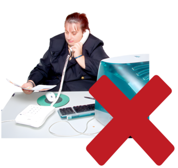 A red cross beside a woman on the phone sitting at a desk with paperwork and a computer.