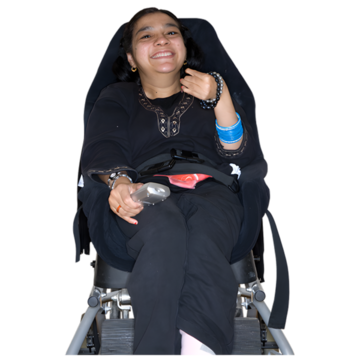 A woman in a wheelchair smiling.