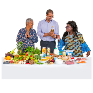 3 people looking at a table of healthy food.