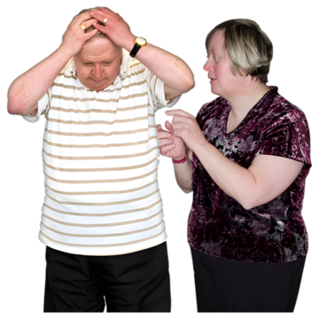A man looking down with his hands on his head and a woman standing beside him helping him.