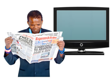 A man reading a newspaper and a tv.