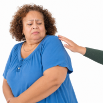 A woman moving away from a hand touching her shoulder.