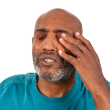 A man with his eyes closed and touching his eyelid with one of his hands.