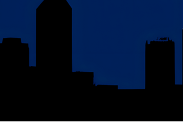 The outline of some buildings at night.
