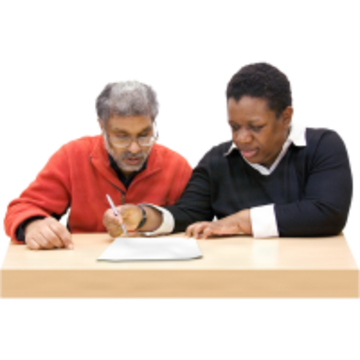 Two people looking at a from.  One person is writing on the form.
