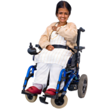 A woman in a wheelchair smiling and pointing to herself.