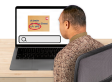 A man at a laptop.  On the screen is an envelope with the postcode circled and a search bar.