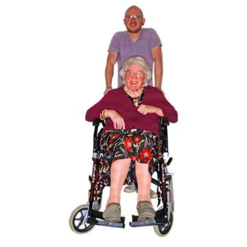 An older woman in a wheelchair with a man standing behind her