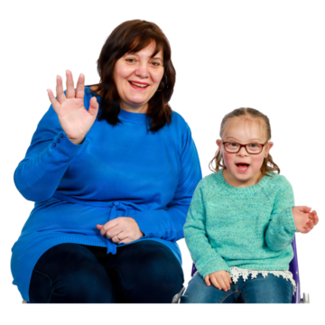 A woman and a young girl smiling and waving at the camera.