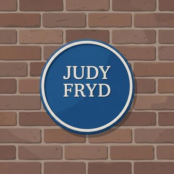 A brick wall with a blue plaque on it that says Judy Fryd.