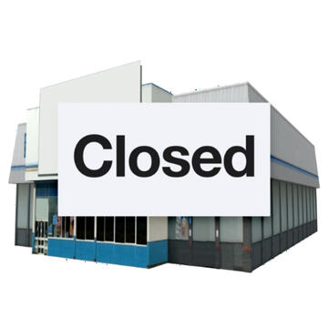 A large building with a sign saying Closed over it