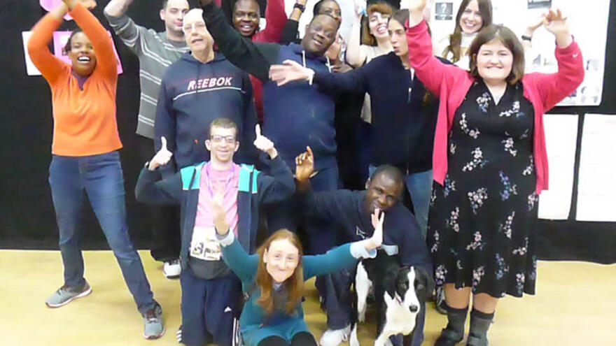 Group of people stood together cheering