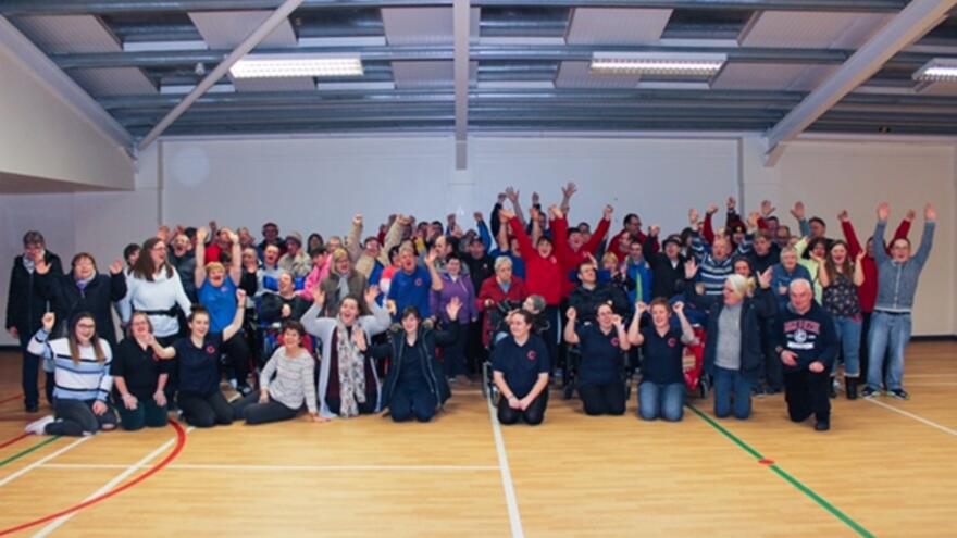 Group of people celebrating in sports hall