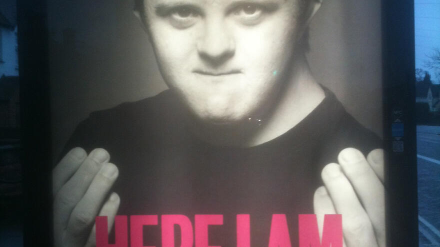 Joe's Here I Am poster in a bus stop