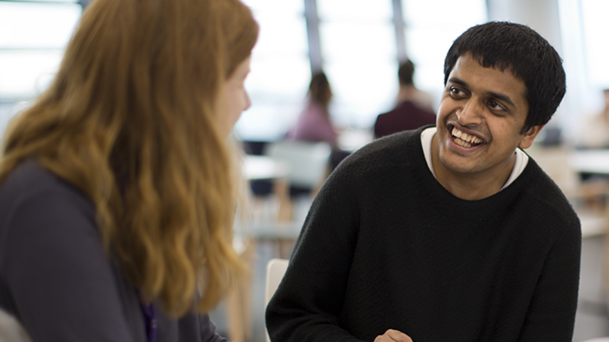 Man smiling at female co-worker in office