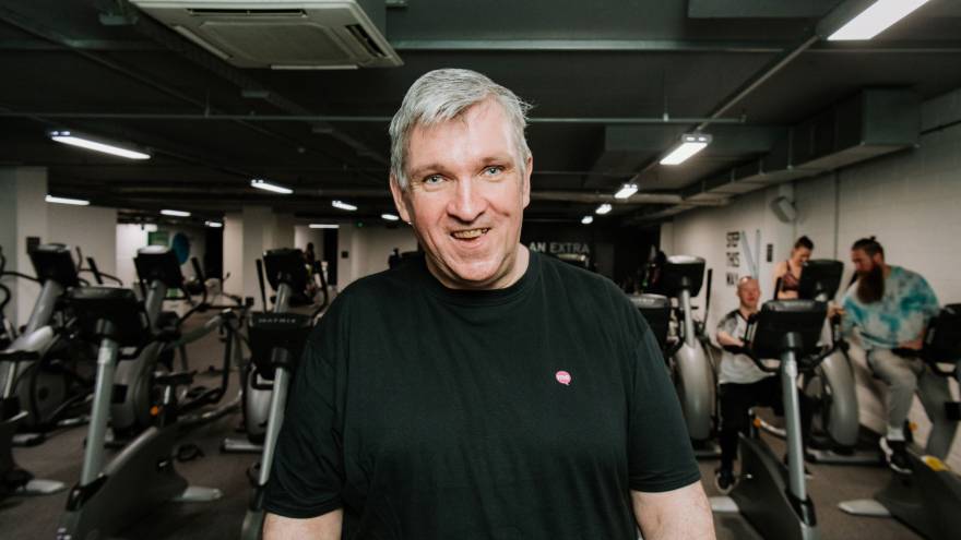 Vince smiling to the camera in a gym