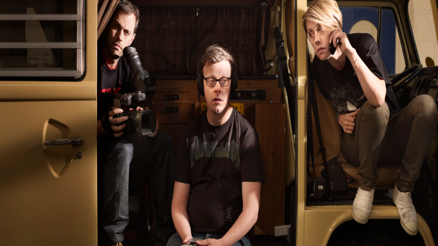 Katie with her two brothers sitting in a camper van