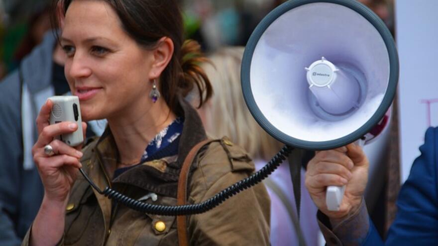 A woman using a loudspeaker