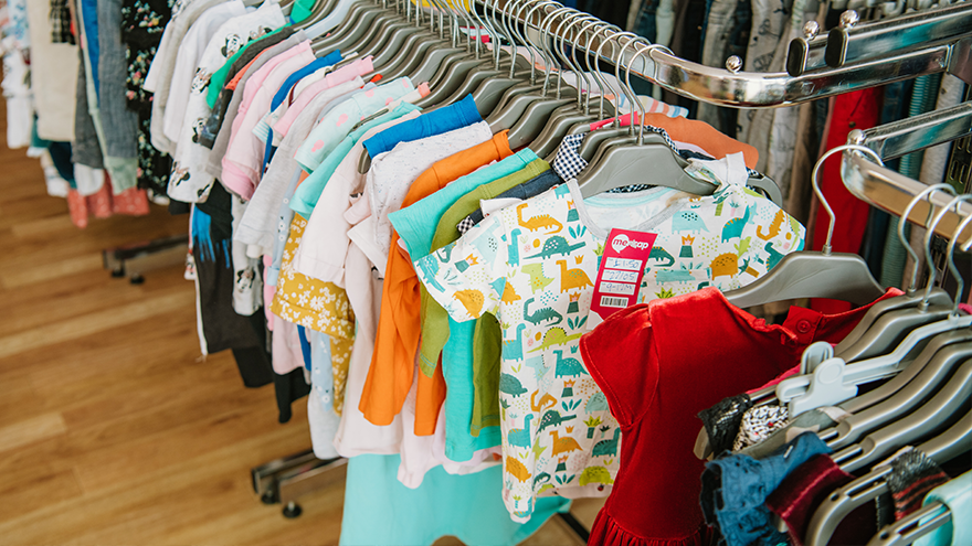 A rail of children's clothes in a Mencap shop