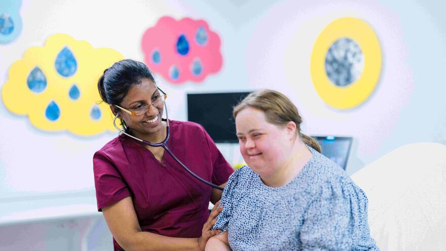 A doctor talking to a patient with Downs Syndrome